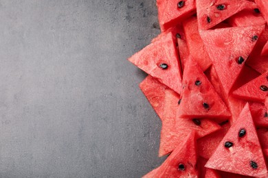 Photo of Delicious fresh watermelon slices on grey table, flat lay. Space for text