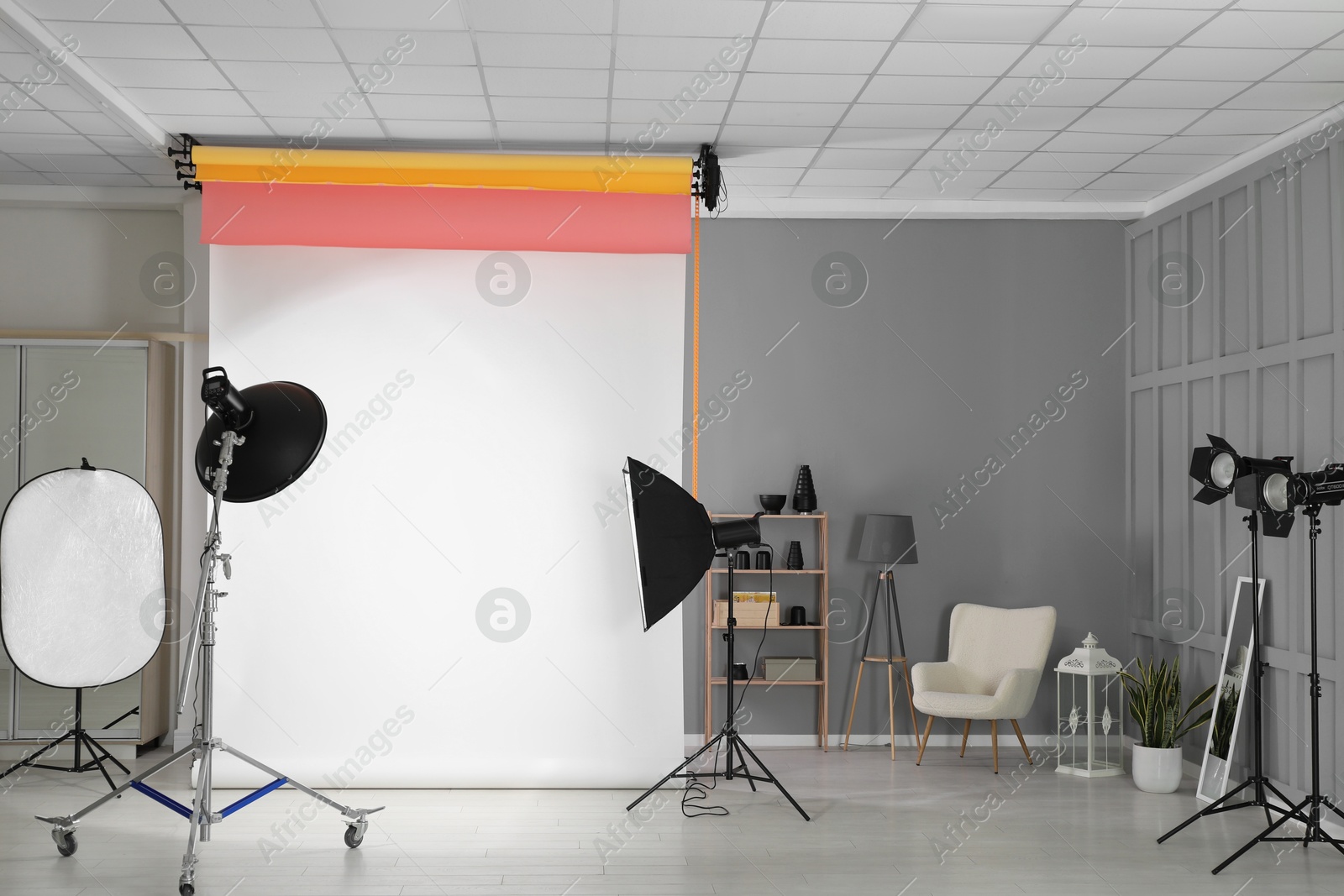 Photo of White photo background and professional lighting equipment in modern studio