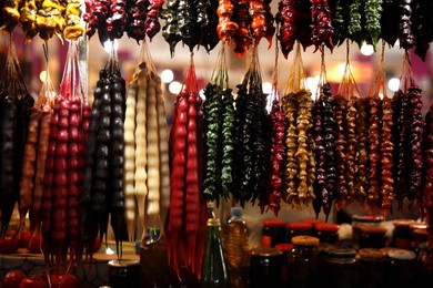 Photo of Bunches of different delicious churchkhelas at market