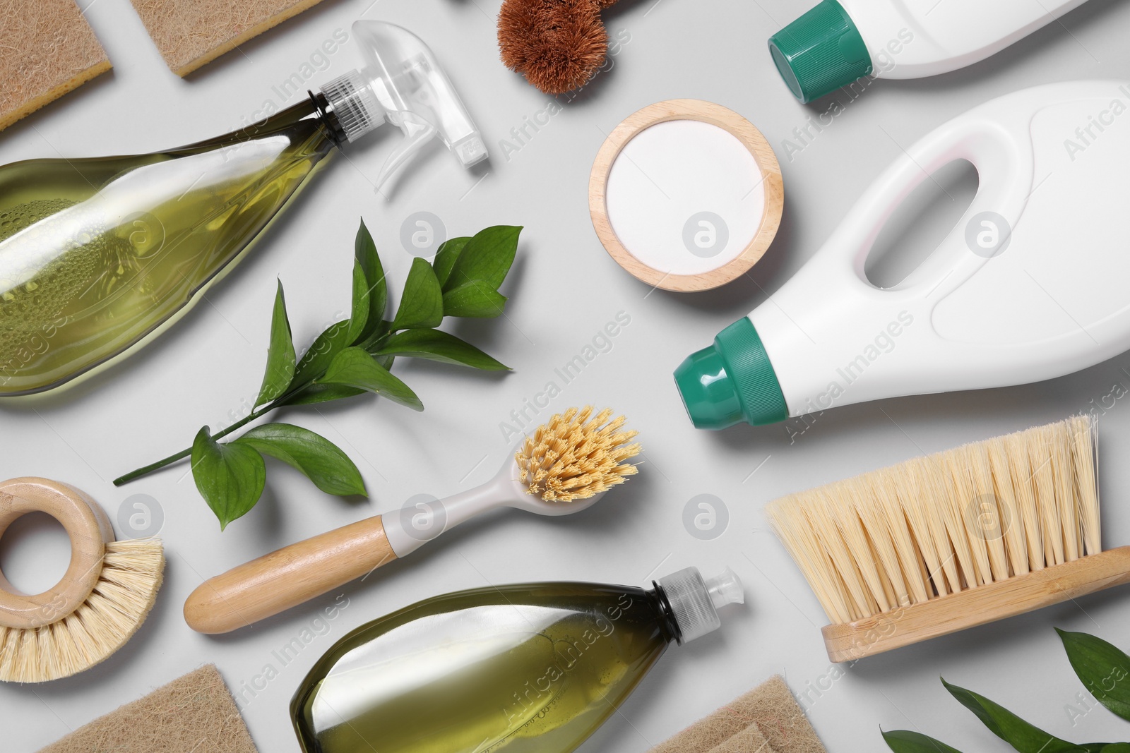 Photo of Flat lay composition with different cleaning supplies on light gray background