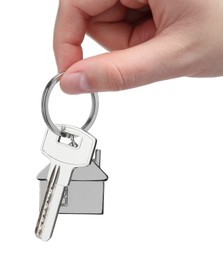 Photo of Woman holding key with keychain in shape of house isolated on white, closeup