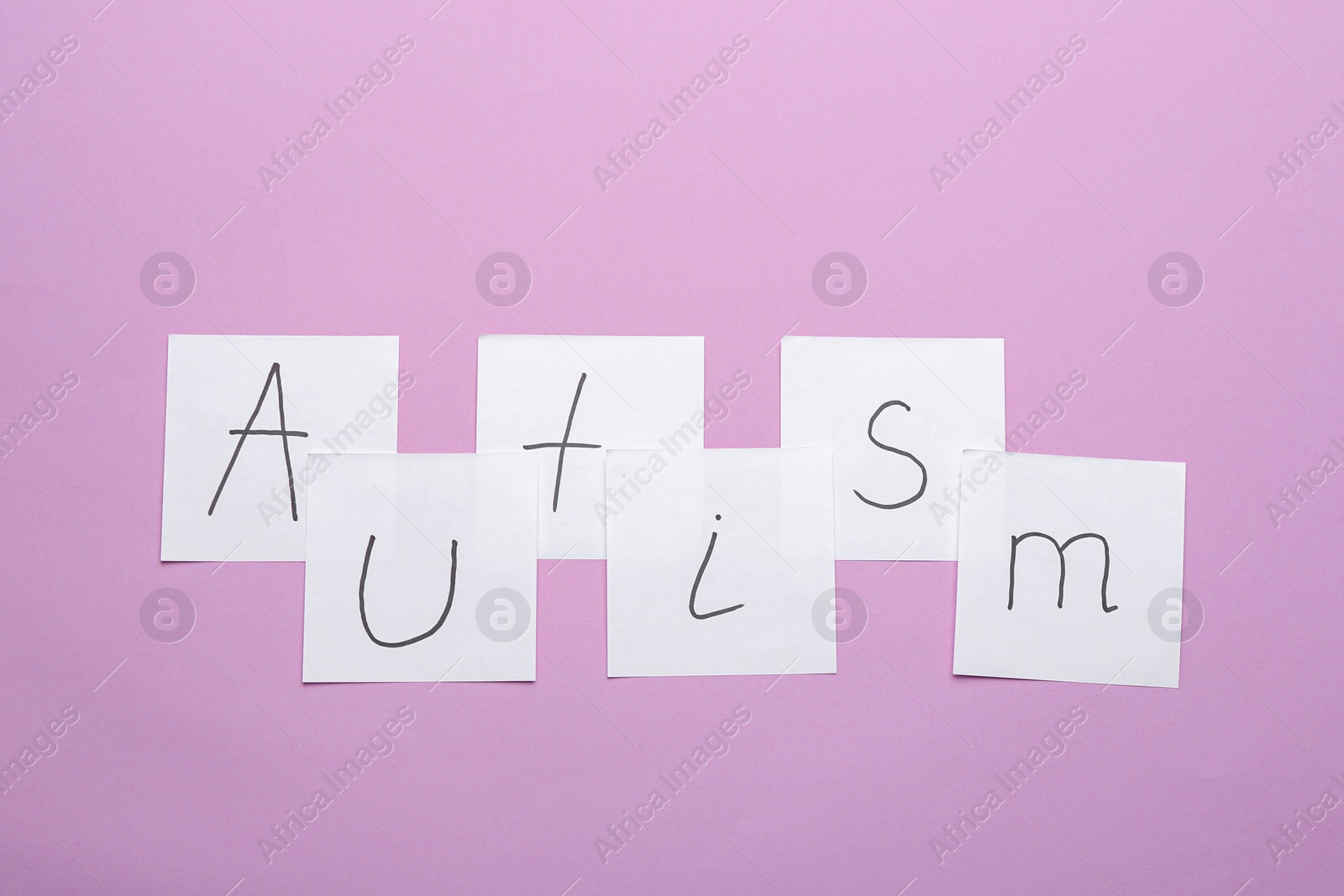 Photo of Notes with word "Autism" on color background