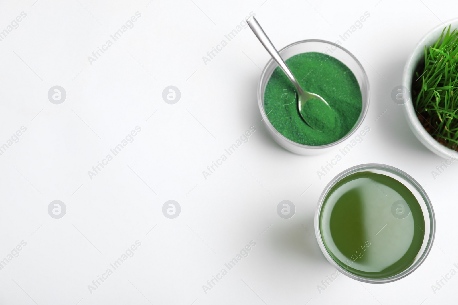 Photo of Composition with glass of spirulina drink on white background, top view