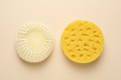 New sponges on beige background, flat lay
