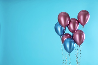 Photo of Bright balloons on color background. Space for text