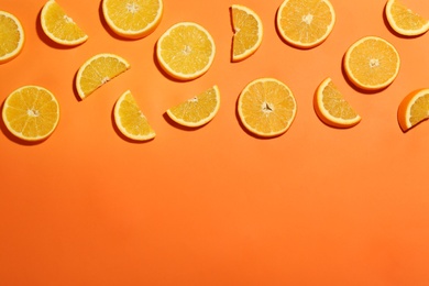 Flat lay composition with fresh ripe oranges on color background. Space for text