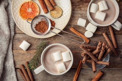 Flat lay composition with hot cocoa drink on wooden background