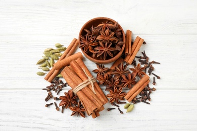 Flat lay composition with mulled wine ingredients on white wooden table