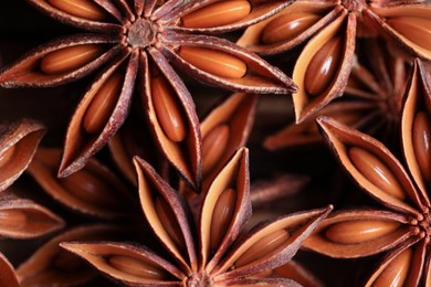 Photo of Many aromatic anise stars on table, flat lay
