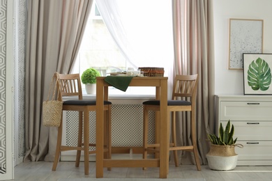 Photo of Beautiful curtains on window in stylish room interior