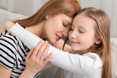 Photo of Portrait of mother and her cute daughter at home