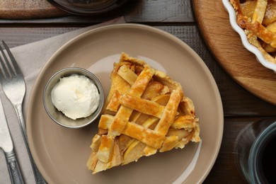 Piece of tasty homemade quince pie served on wooden table, flat lay