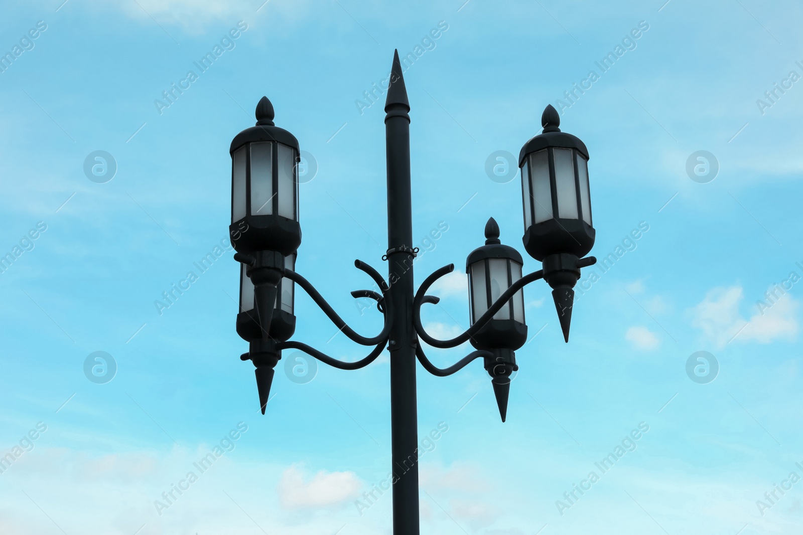 Photo of Old fashioned street light lamp against cloudy sky