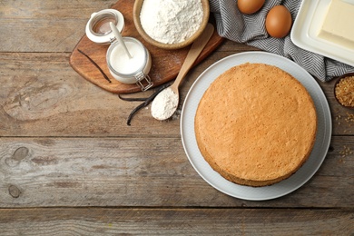 Flat lay composition with delicious fresh homemade cake on wooden table