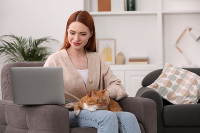 Photo of Woman with cat working in armchair at home, space for text