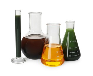 Photo of Laboratory glassware with different types of crude oil isolated on white