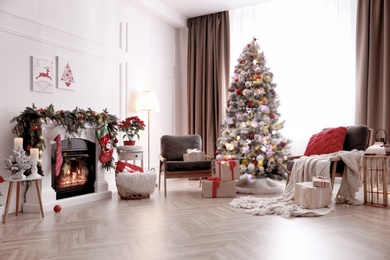 Stylish room interior with fireplace and beautiful Christmas tree