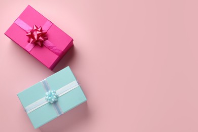 Photo of Bright gift boxes on pink background, flat lay. Space for text