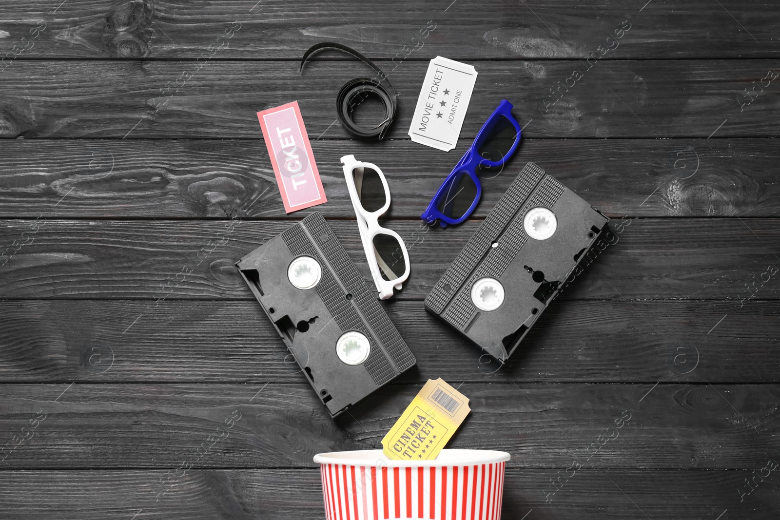 Photo of Flat lay composition with cinema entertainment items on black wooden background