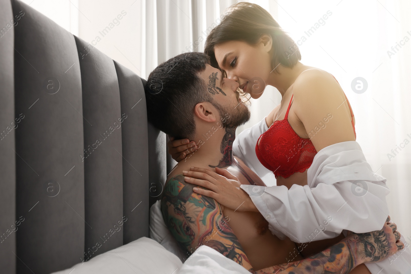 Photo of Passionate couple having sex on bed at home