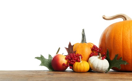 Photo of Happy Thanksgiving day. Pumpkins, leaves and berries on wooden table against white background. Space for text