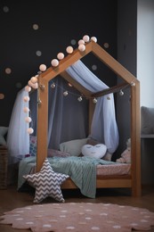 Stylish child room interior with house bed and different toys