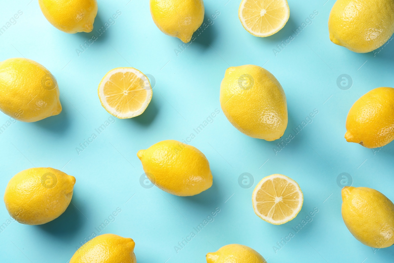 Photo of Flat lay composition with whole and sliced lemons on color background