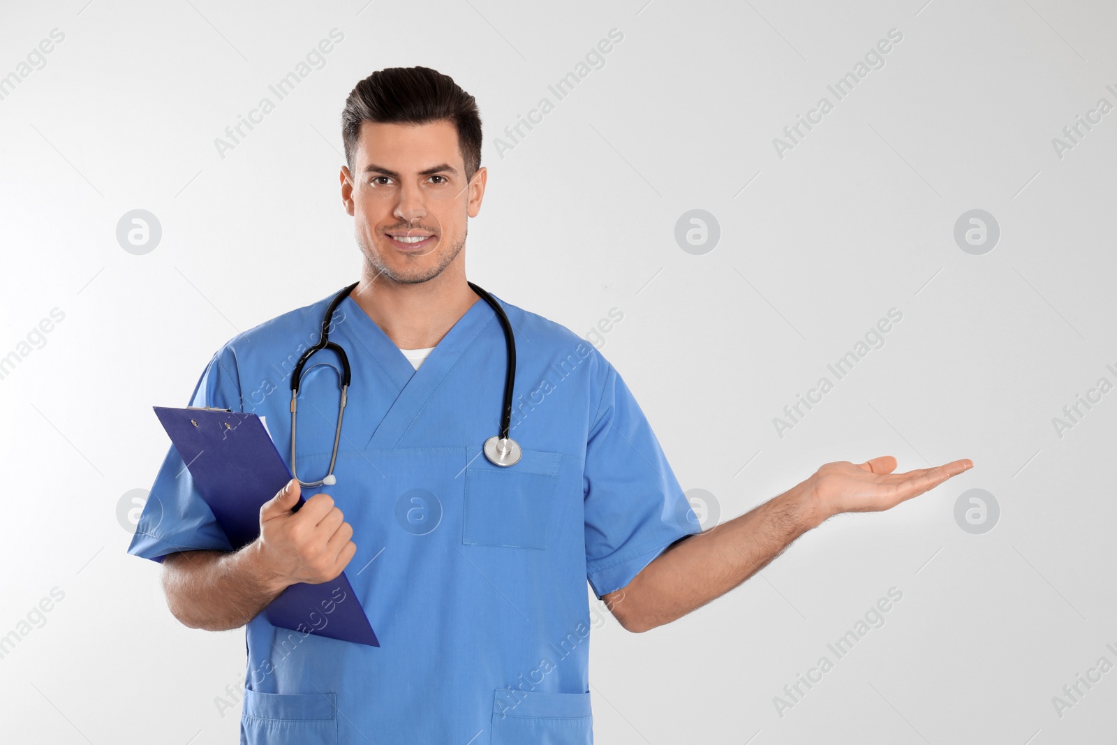 Photo of Doctor with stethoscope and clipboard on light grey background