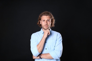 Photo of Portrait of handsome man on black background