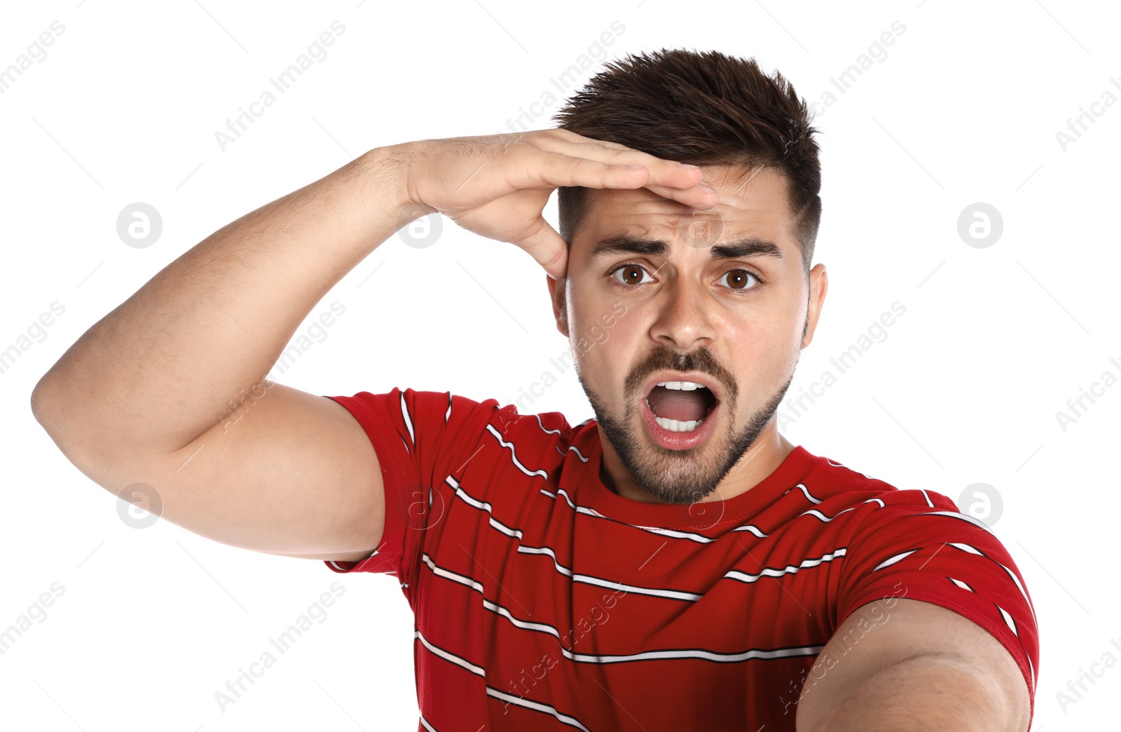 Photo of Emotional young man taking selfie on white background