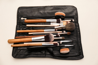 Organizer full of professional tools on makeup artists workplace