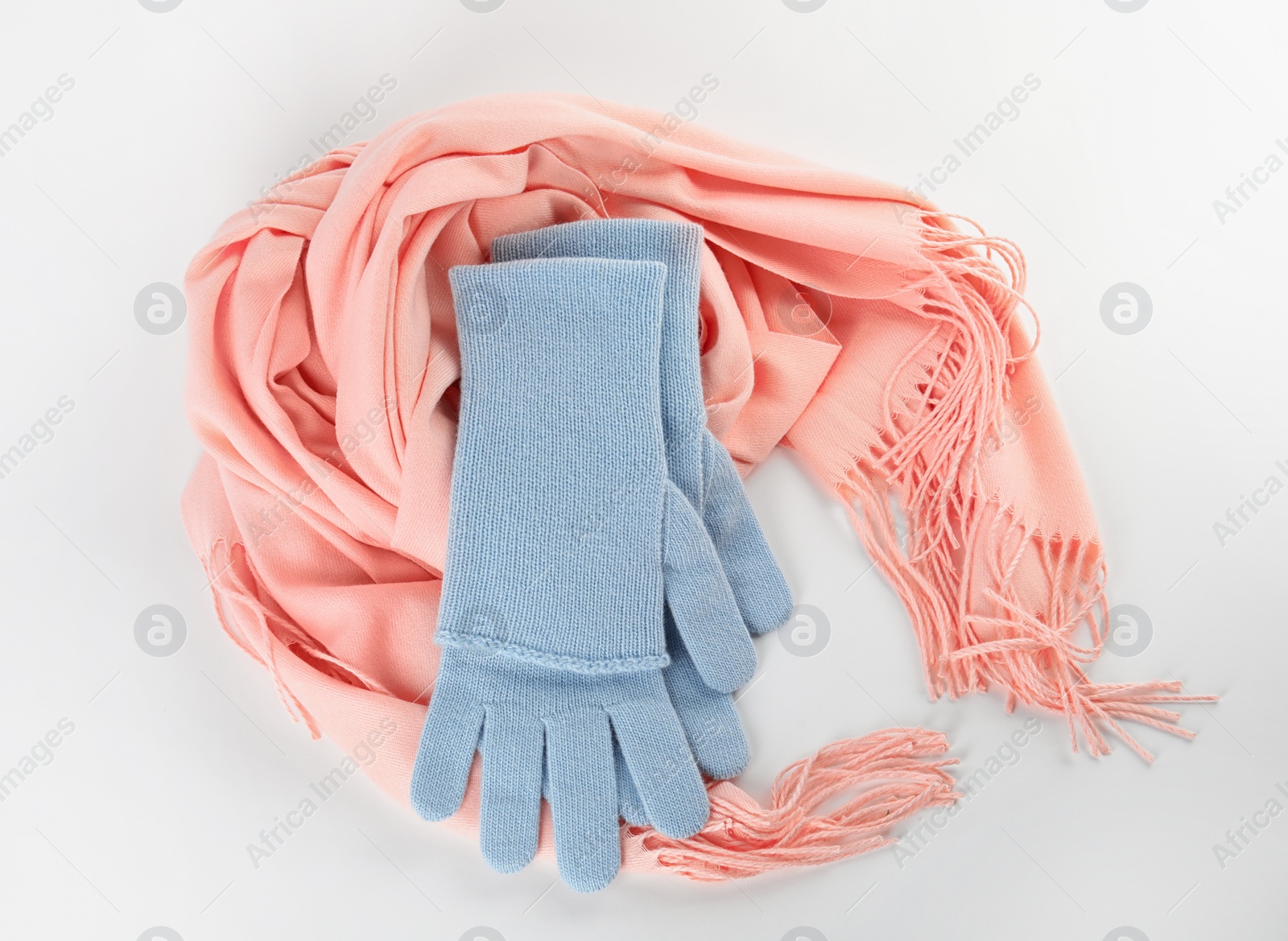 Photo of Stylish gloves and scarf on white background, top view. Autumn clothes