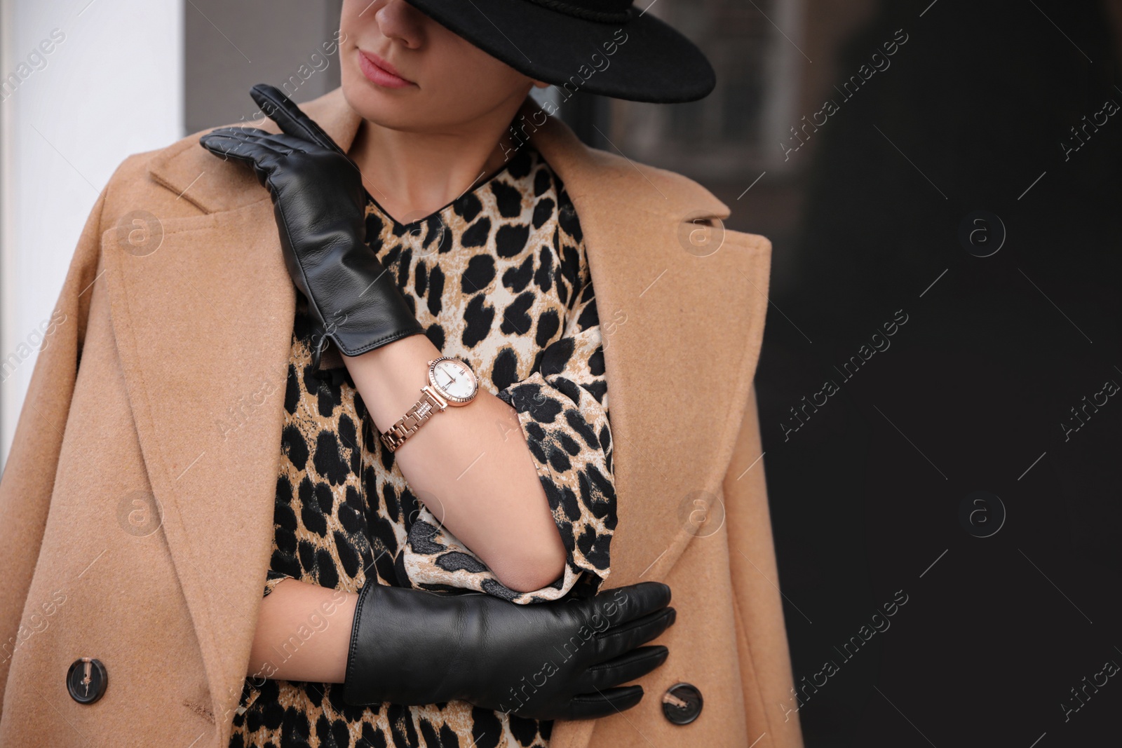 Photo of Young woman in stylish black leather gloves outdoors