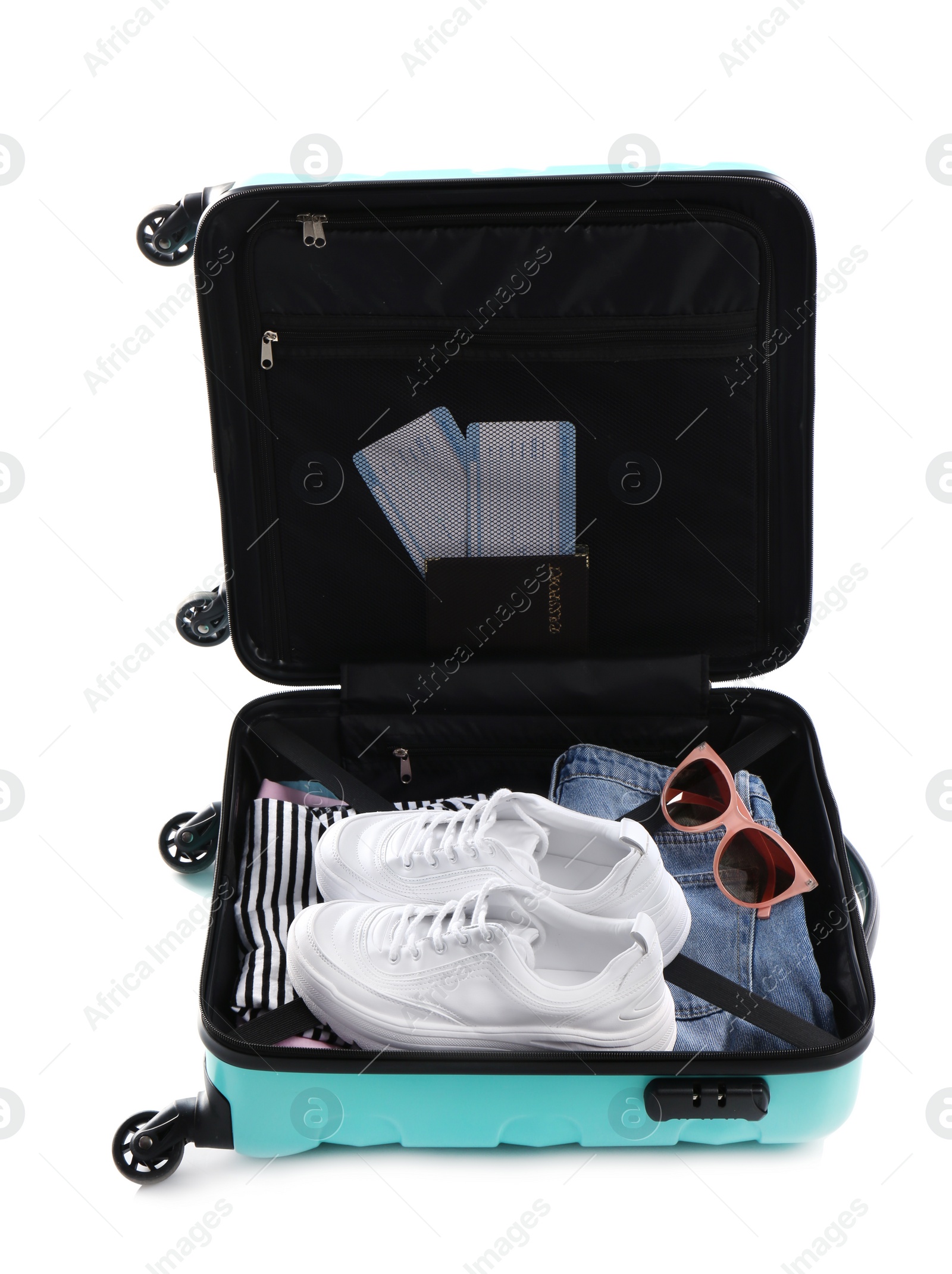 Photo of Open suitcase packed for travelling on white background