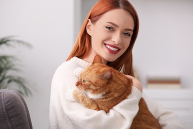 Happy woman with her cute cat at home