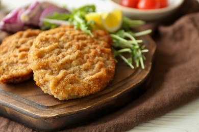 Photo of Tasty schnitzels served on white table, closeup view