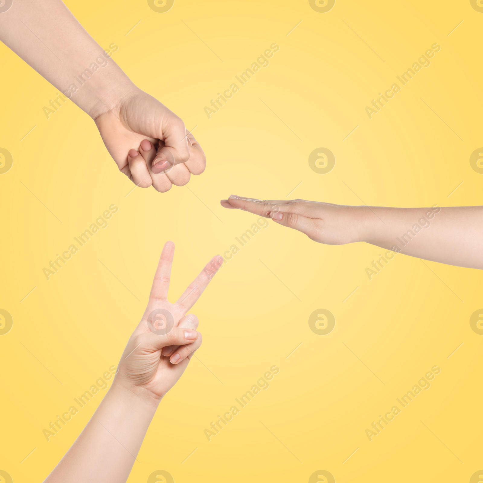 Image of People playing rock, paper and scissors on yellow background, top view