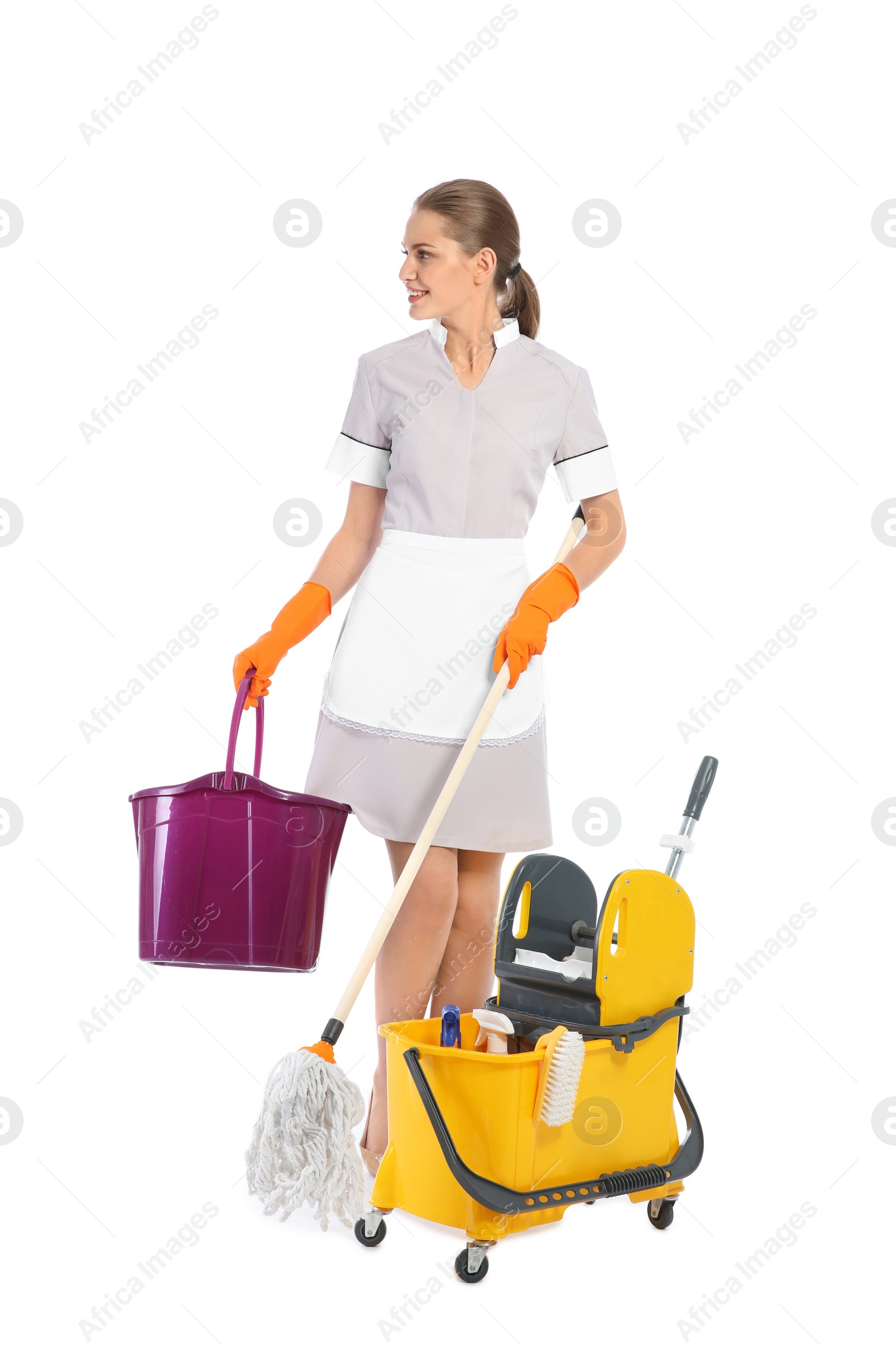 Photo of Young chambermaid with cleaning supplies on white background