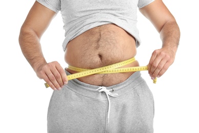 Photo of Overweight man with measuring tape on white background, closeup