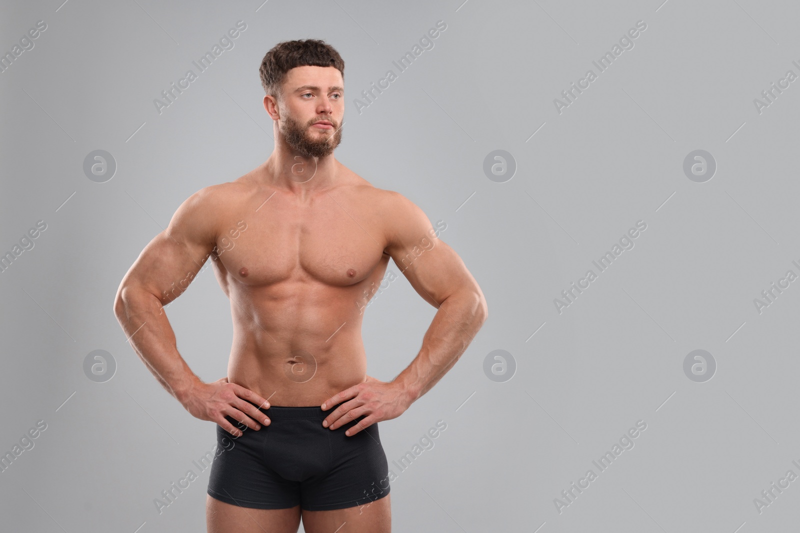 Photo of Handsome muscular man on light grey background, space for text. Sexy body