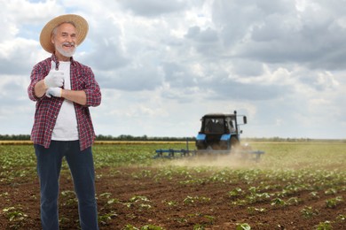 Image of Farmer showing thumbs-up in field. Harvesting season