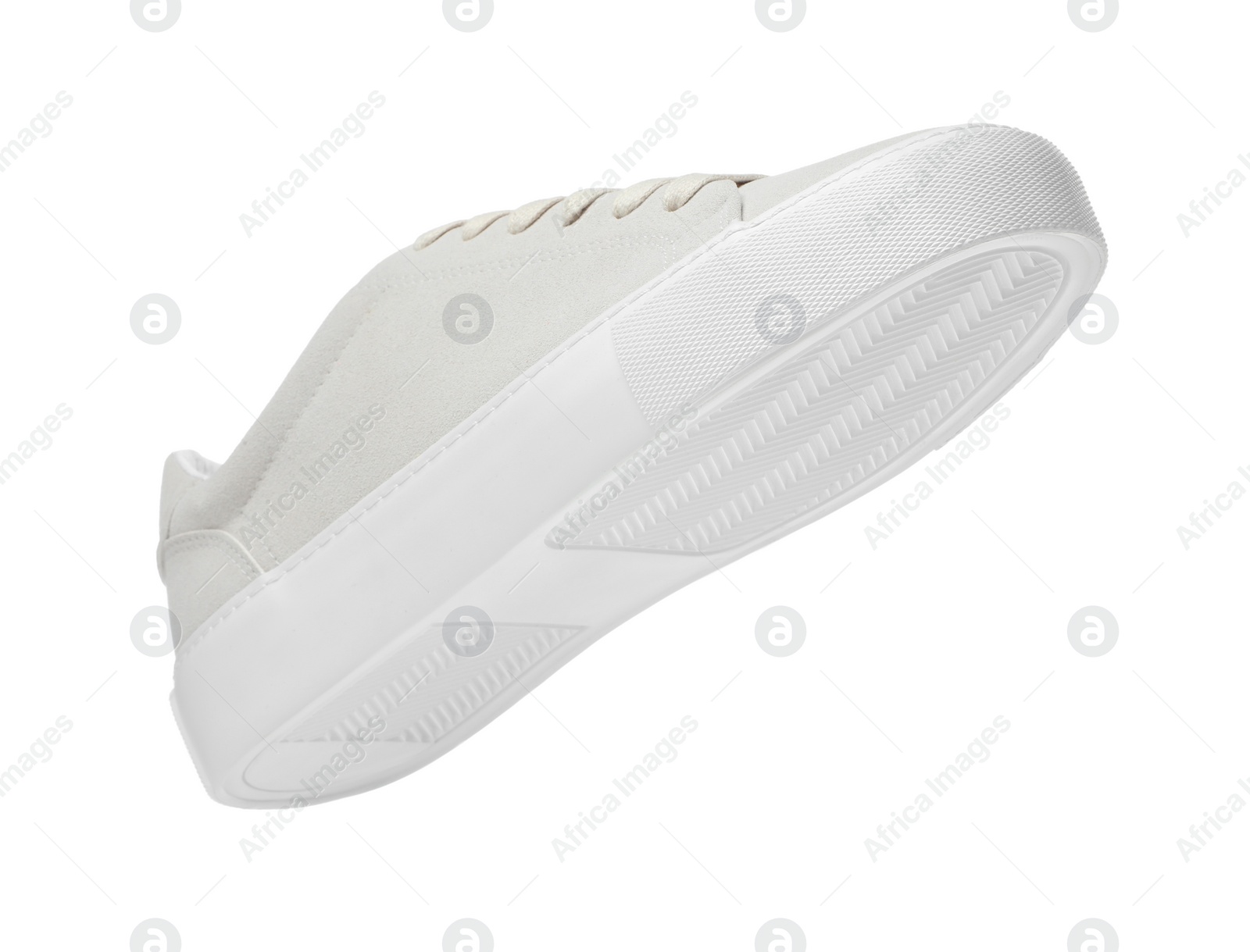 Photo of One stylish beige sneaker isolated on white