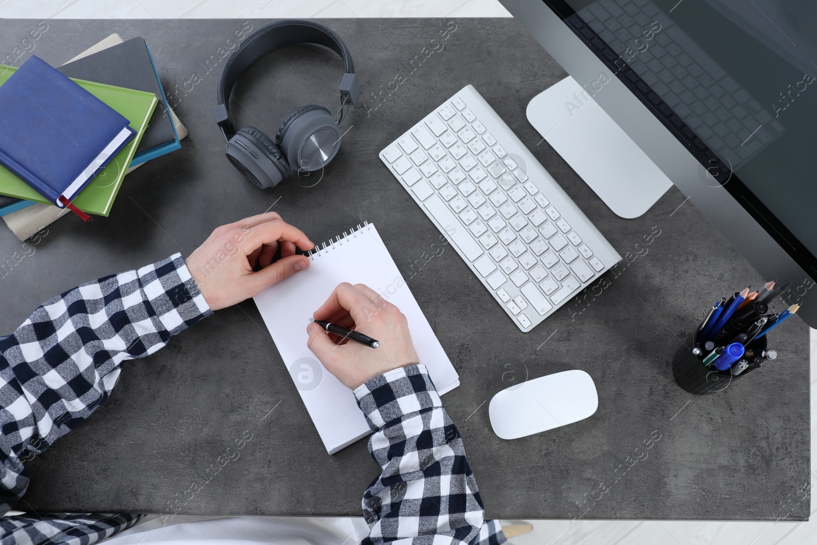 Photo of Man using modern computer for studying at table, top view. Distance learning