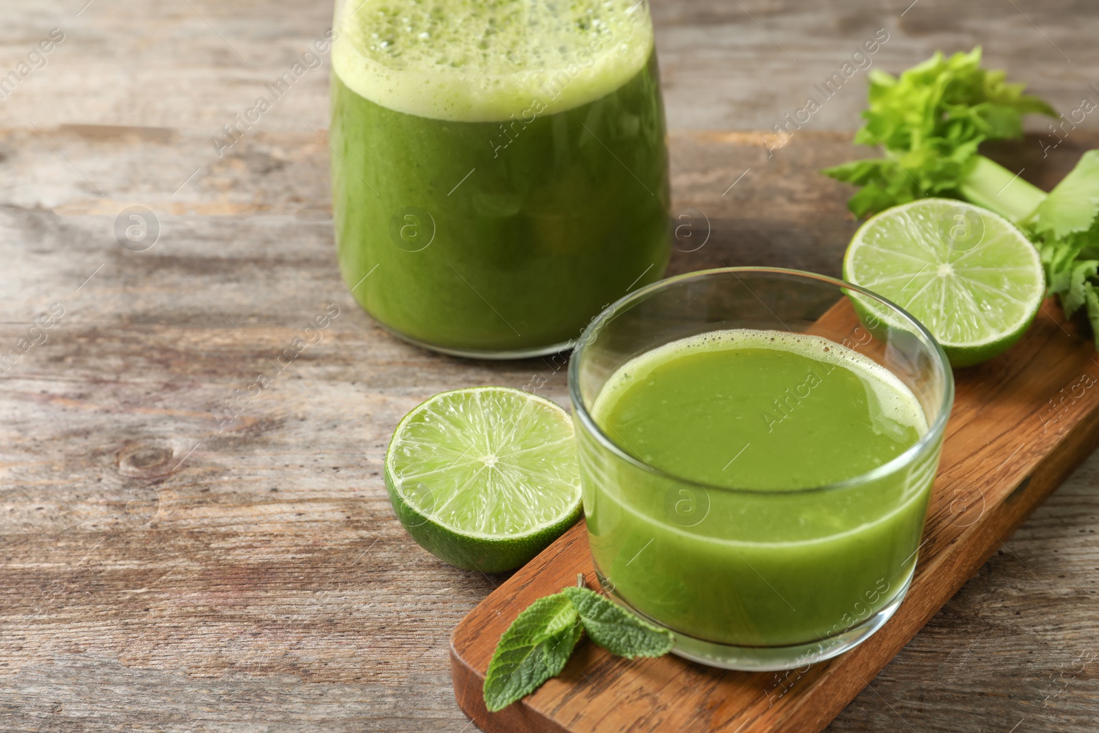 Photo of Glassware with delicious detox juice and ingredients on table