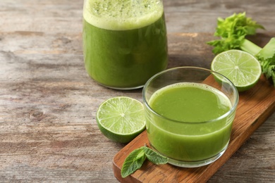 Photo of Glassware with delicious detox juice and ingredients on table