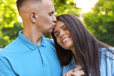 Happy young couple having good time together in park