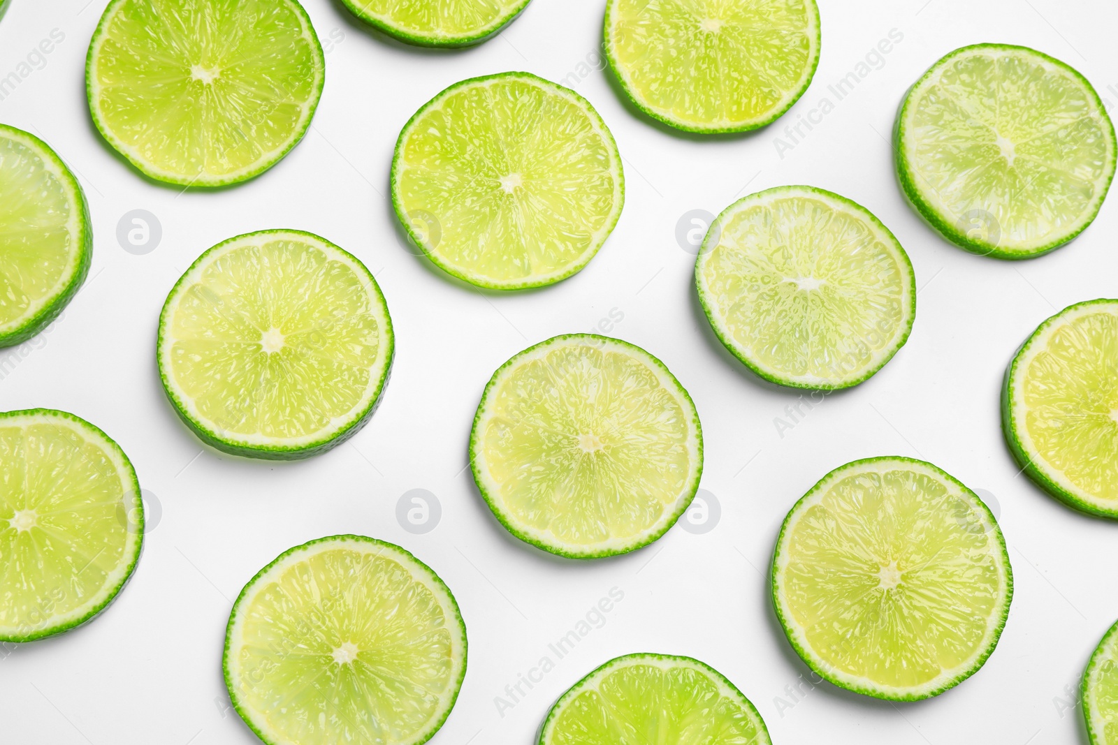 Photo of Juicy fresh lime slices on white background, top view