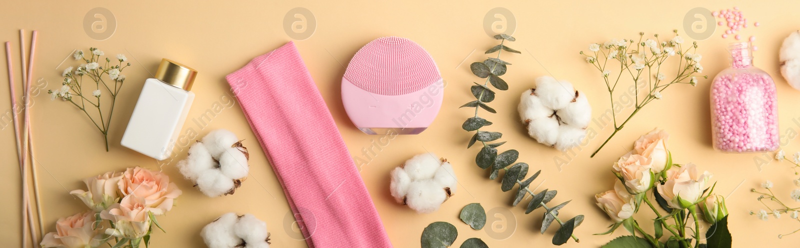 Image of Flat lay composition with face cleansing brush on beige background, banner design. Cosmetic accessory