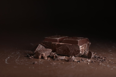 Pieces of dark chocolate on brown table