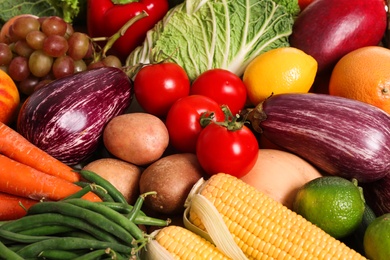Photo of Assortment of fresh organic fruits and vegetables as background, above view